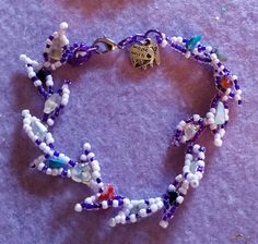 "A vine leaf style, beaded bracelet with a pink/purple theme, using mineral beads in the centre of the design. Clasp and adjustable fastening with classic styling. 8\" 20cm Original design by Sonysree Creations" Adjustable Purple Beaded Bracelets With Heart Beads, Purple Beaded Festival Bracelets, Bohemian Purple Bracelets With Heart Beads, Adjustable Lavender Beaded Bracelets, Lavender Beaded Bohemian Crystal Bracelet, Lavender Adjustable Beaded Crystal Bracelet, Adjustable Beaded Bracelets With Dangling Beads, Adjustable White Beaded Bracelets With Dangling Beads, Adjustable Purple Beaded Crystal Bracelet