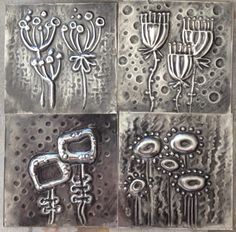 four different metal designs on a piece of silver foil with holes in the middle and flowers at the bottom