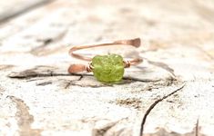 💚Raw and natural tiny peridot stone in adjustable dainty 18g gold or silver ring band with hand hammered ends. Perfect dainty little ring that can fit any fingers of your choice. 💚Peridot - An August birthstone. This gift from the heart of Mother Nature comes with a ton of healing properties. Deep-set calm, good health, restful slumbering, and restoring balance and harmony to the body, mind and soul are just a handful of things you can expect when you say yes to Peridot. Ring size- Fits 5-8 ad Adjustable Green Dainty Rings, Unique Adjustable Green Stackable Rings, Green Birthstone Ring For Promise, Adjustable Green Crystal Gemstone Ring, Adjustable Green Crystal Dainty Ring, Adjustable Green Stackable Crystal Ring, Adjustable Green Crystal Ring For Promise, Adjustable Green Crystal Promise Ring, Minimalist Adjustable Rings With Raw Stone