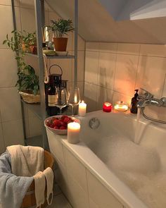 a bathtub filled with candles and strawberries