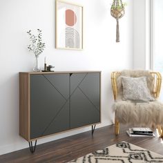 a living room with a chair, rug and pictures on the wall