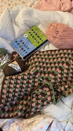 an assortment of crocheted items laid out on a bed