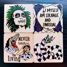 four coasters with different designs on them