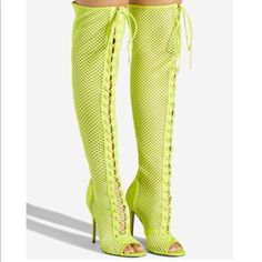 Details A Sexy Over-The-Knee Mesh Boot Featuring A Stiletto Heel, Adjustable Laces, And Back Zipper Closure. Material: Textile/Faux-Suede Calf Circumference: Reg: 16.5"; Wide Calf: 17.5" Color: Neon Yellow Outside Heel Height: 4" Closure: Adjustable Laces Shaft Height: 22" Knee-high Boots For Club In Spring, Summer Party Open Toe Boots, Trendy Summer Party Boots, Trendy Summer Club Boots, Thigh High Heels For Club, Fitted Thigh High Club Heels, Fitted Thigh High Party Heels, Trendy Knee-high Summer Heels, Spring Club Knee-high Heels