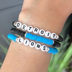 Detroit Lions Bracelet Alternate Blue Black Go Lions! Cheer on your team with these great bracelets! Each bracelet is sold individually. Or buy a Stack of 3! Coordinating earrings also available. Use drop down box to select.  Customization available: If you would like the bracelet to say something else (Grit, Goff,  Hutch, etc) please message me to order.  SIZE  * Stretch Bracelet, size is approximately 6 3/4"-7" (fits small to medium wrists) If you need a different size please let us know in notes at checkout!  PACKAGING  * Each bracelet order will be presented with a Bracelet Island presentation card and wrapped in brown paper dotted w/gold specs and tied with a burlap string. Ready to give as a gift!  CARE  * Made from high quality, long lasting beads with a sturdy stretch cord.   * Kee Personalized Blue Bracelets For Game Day, Blue Team Spirit Beaded Bracelets As Gift, Personalized Blue Bracelets For Sports Events, Blue Team Spirit Jewelry For Game Day, Blue Beaded Bracelets For Team Spirit Gift, Blue Adjustable Beaded Bracelets For Team Spirit, Adjustable Blue Jewelry With Custom Name, Blue Jewelry With Custom Name, Adjustable Black Team Spirit Jewelry