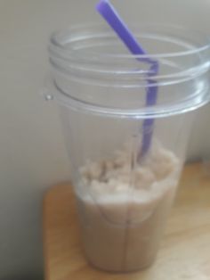 a plastic cup with a purple straw in it