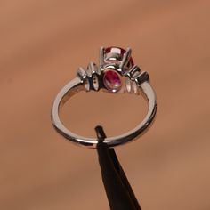 It is lab ruby ring. The main stone is 7 mm*9 mm oval cut.weight about 2.32 carats. The basic metal is sterling silver and plated with rhodium. To change the metal to a solid gold (white/rose) or platinum is also available, please ask for a quotation if you want. You can also go to my shop Home for more elegant rings: https://www.etsy.com/shop/godjewelry?ref=hdr_shop_menu Ruby is July birthstone More ruby rings: https://www.etsy.com/shop/godjewelry?section_id=20709238 Customization is always wel Oval Ruby Ring With Prong Setting In Sterling Silver, Oval Ruby Ring With Sterling Silver Setting, Silver Birthstone Ring With Round-cut Lab-created Ruby, Silver Ruby Ring With Round Cut Lab-created Ruby, Ruby Wedding Ring, Silver Ruby Ring With Hallmark, Round Cut, Elegant Rings, Ruby Wedding Rings, Ruby Rings