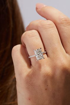 a woman's hand with a diamond ring on it