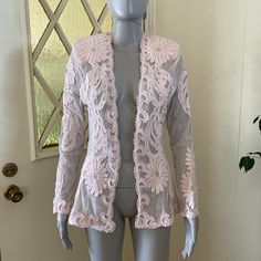 Lovely and versatile sheer pale pink mesh jacket with lace appliques' and scattered clear rhinestones. Long sleeves, open front, hip length. Has shoulder pads which can be easily removed. Measurements are 34" bust, 29" waist, 42" hips, 26" length, 24" sleeve length; this can fit a size small to medium due to the open front. Glam up a sweet little slip dress or toss over a tank top and jeans for a more casual look! Very good vintage condition. Spring Party Outerwear With Lace Trim, Spring Outerwear With Lace Patchwork And Long Sleeves, Fitted Lace Patchwork Outerwear For Spring, Fitted Lace Trim Outerwear For Spring, Party Outerwear With Lace Trim And Long Sleeves, Fitted Long Sleeve Outerwear With Lace Patchwork, Spring Fitted Outerwear With Lace Trim, Long Sleeve Outerwear With Lace Trim For Party, Fitted Outerwear With Lace Trim For Spring