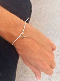 ⭐ STARFISH String Bracelet Discover the charm of this delicate Starfish string bracelet, crafted with high-quality jewelry cord (approximately 1mm in diameter) and a durable 14K gold-filled starfish charm. Available in four elegant string color options: black, cream, grey, and turquoise, this bracelet adds timeless beauty to your jewelry collection. Perfect for everyday wear or as a thoughtful gift for someone special - Materials: Jewelry cord (approx. 1mm diameter), 14k gold-filled Starfish cha Adjustable Starfish Charm Jewelry, Gold Sliding Knot Jewelry For Vacation, Beach Jewelry With Adjustable Star Charm, Summer Bracelets With Starfish Charm, Starfish Charm Bracelet As A Gift, Gold Bracelet With Starfish Charm, Adjustable, Beach Adjustable Jewelry With Star Charm, Adjustable Starfish Charm Bracelet, Adjustable Starfish Charm Bracelet Gift