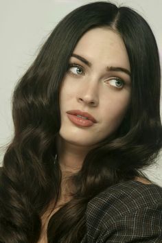 a woman with long dark hair and blue eyes