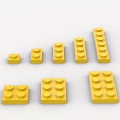 six yellow legos arranged in rows on a white surface