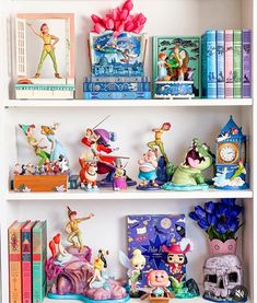 the shelves are filled with figurines and books