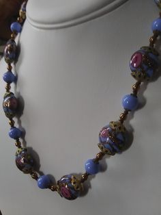 "Gorgeous, authentic Murano, vintage Venetian \"wedding cake\" glass bead handmade necklace with blue, pink, and aventurine flecked gold glass from Murano, Italy, 1970s. Beautiful blue beads of different shapes, with pink rose flowers and gold aventurine flecks threaded through the design of the large beads, alternating with smaller solid blue glass beads and gold-fill and brass spacer beads. Vintage Italian glass artistry from the 70s. A wonderful \"something blue\" for a bride, a perfect weddi Vintage Czech Glass Beaded Necklaces With Polished Beads, Vintage Czech Glass Beaded Necklace With Round Beads, Vintage Style Czech Glass Beaded Necklace, Vintage Czech Glass Beaded Necklaces With Round Beads, Vintage Czech Glass Necklace With Polished Beads, Vintage Czech Glass Jewelry With Large Beads, Vintage Czech Glass Polished Beads Necklace, Vintage Jewelry With Large Czech Glass Beads, Vintage Czech Glass Necklaces With Polished Beads