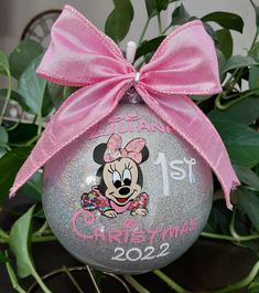 a minnie mouse christmas ornament with a pink bow