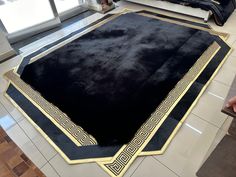 a large black rug on the floor in a room