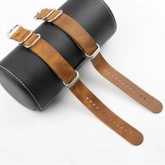 two straps are attached to a black leather case