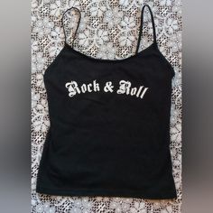 Up For Sale Is This Nwot Womens Spaghetti Strap Black "Rock & Roll" Tank Top - L. This Black Tank Top From Fuuh Is The Ultimate Addition To Any Woman's Wardrobe. With Spaghetti Straps And A Relaxed Fit, It's Perfect For Casual Occasions. The Solid Pattern And Round Neckline Give It A Classic Look, While The Strap Accents Add A Touch Of Style. Made From 100% Cotton, This Cropped Tank Top Is Comfortable To Wear In Any Season. It's Great For Juniors Who Want To Show Off Their Love For Rock And Roll Black Y2k Tank Top, Rock And Roll Music, Black Y2k, Outfit Combos, Digital Closet, Graphic Tank Tops, Spaghetti Strap Tank Top, Black Tank Top, Fit Ideas