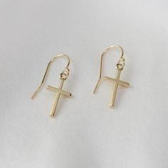 14k gold small cross earrings. 14K yellow gold cross earrings. Great Christmas gift. Triangle earrings show that you view the world from a different angle. These make a unique gift for the lady that already has everything.  The earrings will arrive in a nice gift box ready for someone special! The small cross charm is 14k gold, it is about 16mm x 9mm. It is small. 14K solid gold ear wire The earrings will be shipped in a nice gift box. Gold Cross Earrings, Earrings Christmas, Small Crosses, Triangle Earrings, Cross Earrings, Gold Cross, Cross Charms, Great Christmas Gifts, Ear Wire