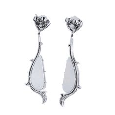 Known for its enchanting dance with light, the moonstone is a playful and intriguing stone that translates beautifully into jewelry design. Handmade in 18kt white gold, this set of earrings showcases 29.24ct crescent-shaped Milky Moonstone that are embraced by .99ct of F/G VS graded diamond pave. The diamonds and milky moonstone are suspended by 3.68ct moonstone pinned to the stem of the earring. SKU: 15832 White Marquise Platinum Earrings, Luxury White Marquise Earrings, Silver Marquise Earrings With Single Cut Diamonds, White Gemstone Earrings For Evening, White Dangle Earrings With Single Cut Diamonds, Elegant Moonstone Drop Earrings, Elegant Moonstone Earrings For Formal Occasions, Crescent Shape, Diamond Drops