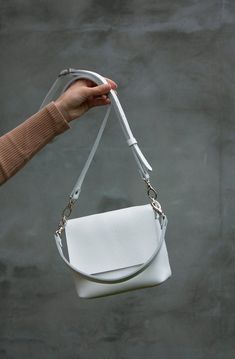 If you need a white minimalist leather handbag, so this mini one will fall into your heart. You can be sure that you will want more than one such crossbody bag in other colors and sizes. This white handbag is a great choice for a Christmas gift or for another occasion! HIGH QUALITY LEATHER The bag is made of high quality genuine leather. The leather is soft and pleasant to use. The structure and relief of the leather is very natural. The design will look perfectly with any style of clothing. Thi White Leather Handbag, Minimalist Crossbody Satchel With Detachable Strap, Minimalist Clutch Shoulder Bag With Removable Pouch, Minimalist Clutch Bag For Everyday Use, Minimalist Clutch For Everyday Use, Minimalist Crossbody Shoulder Bag For On-the-go, Minimalist Crossbody Satchel With Adjustable Strap, White Leather Satchel With Mobile Phone Bag, Minimalist Clutch Shoulder Bag With Detachable Strap