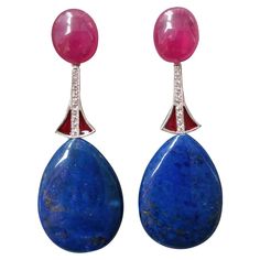 2 large oval Ruby cabochons support 2 white gold elements, diamonds and red enamel, at the bottom we have 2 drops of natural Lapis Lazuli . In 1978 our workshop started in Italy to make simple-chic Art Deco style jewellery, completely handmade and using the typical gemstones of that period (1920-1930 circa) : genuine Jades, Turquoise , Coral, Lapis Lazuli and other color gemstones set in white Gold, Diamonds and Enamels. We always put particular attention on the details of the antique jewels,lik Sparkly Jewelry, Chic Art, Simple Chic, Estilo Art Deco, Modern Earrings, Modern Jewelry, Lapis Lazuli, Art Deco Fashion, Gold Diamond