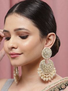 These exquisite gold-toned 2-layer crescent-shaped chandbali earrings come with kundan stone studs & beads, are gold-plated, and are secured with a post and back closure. These handcrafted chandbalis can be styled with any ethnic outfit for a dramatic impact, or an evening outfit to complete a dazzling look. Eitherway, complements are all yours! Product color may vary based on the monitor or screen you are using.See FAQ for more details. Size Length: 11 cm Details Material: BrassStones: Kundan & Heavy Gold Chandbalis For Festive Occasions, Festive Gold Bollywood Chandbalis, Gold Heavy Chandbalis For Diwali, Gold Bollywood Chandbalis For Festive Occasions, Gold Chandbalis For Diwali Festive, Gold Bollywood Chandbalis For Diwali, Festive Gold Bridal Chandbali Earrings, Cutdana Chandbali Chandelier Earrings For Party, Gold Chandbali Earrings With Cutdana