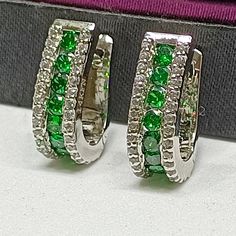 1.11Ct Simulated Emerald And Diamond 14 Carat White Gold Over Women's Hoop Earring MetalSterling Silver Metal Purity925 Metal Finish14 k white Gold Over  Main Stone Details  Stone TypeEmerald and Diamond Stone Shaperound Stone ColorGreen Stone ClarityVVS1 Stone TreatmentSimulated  Total Carat Weight (approx.)1.11 ct Jewelry TypeEarring Shipping Policy 1.       We do International Fast & Economy shipping. 2.       We ship to Confirmed Addresses by Paypal Only 3.       Please provide your Full Add Gia Certified Hoop Jewelry For Anniversary, White Hoop Jewelry With Channel Set, White Channel Set Hoop Jewelry, Green Diamond Hoop Earrings Fine Jewelry, Fine Jewelry Green Sterling Silver Hoop Earrings, Gia Certified White Gold Huggie Jewelry, White Hoop Earrings With Channel Set, White Hoop Earrings Channel Set, White Channel Set Hoop Earrings