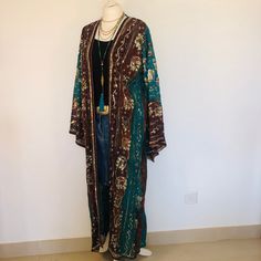 "A Beautiful Long Boho Hippie Chic Kimono Jacket. Sequinned,Beaded and Embroidered ; Perfect for Holidays,Parties,Weddings and Celebrations as a Cover Up. Handmade in India from a Vintage Sari , so completely unique and sustainable. The Fabric is a Gorgeous and Flattering Teal and Chocolate Chiffon .  The Exquisite embellishment features a Lush Gold floral print, and 1000's of Glittering Gold Beads ,Mother of Pearl beads and Sparkling Sequins. The size will fit and flatter sizes  S M L.      UK 12 to 18 , US 8 to 14. EU 38 to 46. The length is 126 cm / 50 \". The Kimono style sleeves are 58 cm / 23 \". The fabric is delicate ,so please hand wash in cool water,mild soap and dry and store flat . Timeless Boho Chic . To see more unique designs like this please visit my Etsy Boutique at: https Bohemian Floor-length Kimono For Festive Occasions, Festive Floor-length Bohemian Kimono, Festive Bohemian Floor-length Kimono, Bohemian Festival Kaftan With Sequins, Bohemian Sequin Kaftan For Festivals, Bohemian Beaded Outerwear For Fall, Bohemian Long Sleeve Party Kaftan, Bohemian Long Sleeve Kaftan For Party, Bohemian Beaded Fall Outerwear