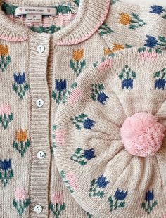 a sweater with a flower on the front