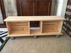 a wooden shelf sitting on top of a carpeted floor