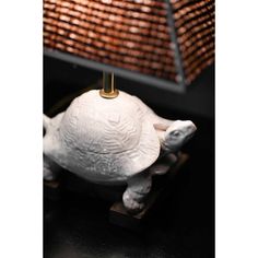 a white turtle lamp sitting on top of a table