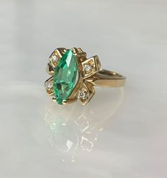 Emerald Butterfly Ring, Marquise Emerald Ring, Marquise Engagement Ring, Vintage Emerald Ring, Emerald Diamond Ring, Emerald Rings for Women A dreamy and delicate vintage emerald ring featuring a marquise shaped 1.32 carat vibrant Colombian emerald accented by 4 single white diamonds weighing 0.31 carats set in solid 14k yellow gold. *Ring size: US 6 *Complimentary resizing is available up to 3 sizes larger or smaller than stated size. Green Marquise Emerald Rings, Green Marquise Cut Emerald Ring, Green Marquise Diamond Ring Fine Jewelry, Emerald Marquise Ring For May Birthstone, Vintage Green Marquise Emerald Ring, Heirloom Green Ring For May Birthstone, Fine Jewelry Green Topaz Ring With Center Stone, Green Heirloom Birthstone Ring With Center Stone, Heirloom Green Birthstone Ring With Center Stone