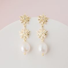 CELESTE // Gold celestial star and pearl drop earrings - Gold stars, adorned with cubic zirconias and freshwater pearls.  14k gold plated brass.  Your jewellery comes in a beautiful suedette pouch for safe keeping. Please note, that for hygiene reasons earrings cannot be returned. Celestial Dangle Earrings For Wedding, Celestial Style Drop Earrings For Wedding, Elegant Star-shaped Pearl Drop Earrings, Celestial Silver Earrings For Wedding, Celestial Style Dangle Jewelry For Wedding, Elegant White Star-shaped Pearl Earrings, Star-shaped Pearl Drop Earrings As Gift, Elegant Star-shaped Pearl Earrings, White Star-shaped Earrings For Wedding