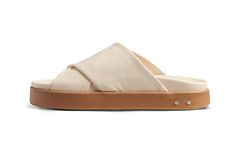 Introducing the HEN leather platform slide sandal. Crafted with two super-soft leather upper straps and a leather-wrapped memory foam molded footbed nestled into a rubber outsole, this sandal is the epitome of modern + classic styling. Our commitment to sustainability is evident in our use of vegetable-tanned leathers, recycled and recyclable products, packaging, and leather sourced from tanneries certified by the Leather Working Group. Read more in the Our Footprint section of our site. So you' Eggshell Color, Platform Slide Sandals, Products Packaging, Winter Lookbook, Clog Heels, Shearling Boots, Summer Lookbook, Leather Platform Sandals, Platform Slides