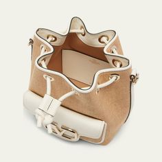 Valentino Garavani "Loco" bucket bag in polyester, metal, and raffia  Detachable flat top handle  Detachable, adjustable web shoulder strap Can be worn as a top handle or shoulder bag  Drawstring closure  Exterior, VLOGO front flap pouch  Lining: Cotton Approx. 7.5"H x 6.3"W x 4.3"D Made in Italy Designer Top Handle Bucket Bag For Errands, Designer Bucket Bag With Detachable Strap For Errands, Designer Bucket Satchel With Handles, Luxury Bucket Hobo Bag For Errands, Luxury Bucket Shape Hobo Bag For Errands, Designer Cream Bucket Bag, Designer Bucket Hobo Bag With Gold-tone Hardware, Designer Cream Bucket Bag With Detachable Handle, Top Handle Bucket Bag With Detachable Strap For Errands