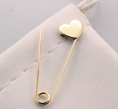 14k Yellow Gold Safety Pin Heart Shape Brooch Handmade in USA Yellow gold safety pin made of solid 14K gold 1.25'' long The jewelry we make is made with recycled and re-refined environmentally responsible precious metals. Please note these pins are not mass produced or cast , each and every one is handmade in our shop with care and great attention to detail. 14K Solid Gold Pin's are made in USA and are of the highest quality. They are nicely polished and stamped for authenticity. Safety Pin Heart, Safety Pin Brooch, Safety Pin Earrings, Brooch Handmade, Gold Pin, Brooches Handmade, Tattoo Shop, Safety Pin, Pin Brooch