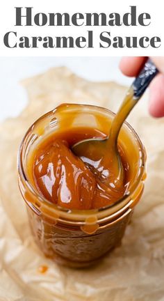 homemade caramel sauce in a small glass jar with a spoon sticking out of it