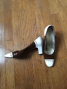 1960's/70's brown and white Andrew Geller high heel shoes. Has a few indents. Marked as a size 7, fits better as a 6.5/7 Retro White Block Heel Heels, Retro White 4-inch Heels, Retro Brown Heels With Block Heel, Vintage Heels With Contrasting Heel Counter, Retro White Pointed Toe Heels, Retro White Heels With 4-inch Heel, Vintage White Round Toe Heels, Vintage White Heels With Round Toe, White Retro Heels With Pointed Toe