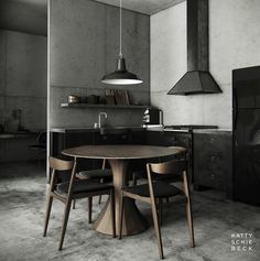 a round table with four chairs around it in the middle of an industrial style kitchen