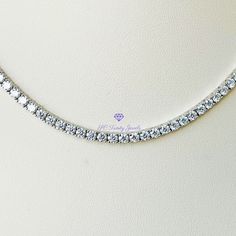 Elegant, with amazing fire and brilliance is the only way to describe this gorgeous necklace. Wear it to a special occasion or work, it is sure to capture everyone's attention. Pair this necklace together with my 3mm Moissanite tennis bracelet, and my 3mm Moissanite wedding band for a beautiful set. CERTIFICATION: Along with your necklace you will receive a GRA certificate of authenticity and warranty card. RESIZING: Each setting cannot be separated, therefore I will not be able to resize the ne Silver Round Cut Tennis Necklace For Anniversary, Tennis Necklace With Sparkling Round Cut Stones As Gift, Silver Moissanite Tennis Necklace, Silver Diamond Cut Tennis Necklace Gift, Dazzling Diamond White Tennis Necklace As A Gift, White Gold Cubic Zirconia Tennis Necklace Gift, Gift White Gold Tennis Necklace With Vvs Clarity, White Moissanite Tennis Necklace Perfect As A Gift, Moissanite Tennis Necklace With Brilliant Cut As A Gift