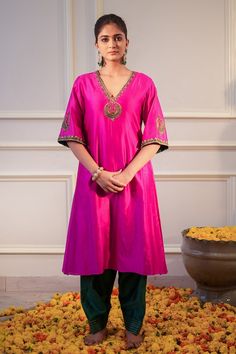 Hot pink kurta featuring zari hand embroidered neckline and sleeves. Paired with a bottle green salwar. - Aza Fashions Pink V-neck Kurta With Zari Work, Celebration Tissue Silk Kurta With Cutdana, Designer Pink Tussar Silk Kurta, Pink Tussar Silk Traditional Wear For Reception, Festive Pink Tussar Silk Kurta, Pink Slub Silk Traditional Wear For Celebration, Festive V-neck Kurta With Pallu, Celebration Cotton Silk Kurta, Navratri Tissue Silk Kurta For Celebration