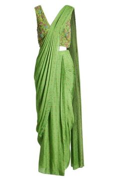 This saree has a hand-embroidered cropped top with intricate beadwork and lustrous sequins and is paired with a skirt featuring attached wraparound draping. This outfit is prestitched, so you can put it together in 30 seconds or less. V-neck Top has hook-and-eye closure; skirt has hidden side-zip closure Top and skirt feature hook-and-eye attachments for easy drape adjustments Lined 100% viscose Spot clean Made in India Asian & Pacific Islander Owned/Founded Traditional Embellished Pre-draped Saree In Raw Silk, Traditional Pre-draped Art Silk Saree With Sequins, Transitional Bollywood Style Embellished Pre-draped Saree, Traditional Embellished Pre-draped Saree For Festive Season, Embellished Art Silk Pre-draped Saree For Festivals, Festive Embellished Art Silk Pre-draped Saree, Navratri Embellished Silk Saree, Embellished Silk Saree For Navratri, Traditional Embellished Art Silk Pre-draped Saree