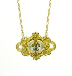 "This amazing one of a kind necklace is a beauty!! This unique piece is handmade featuring a 1940s oval camphor glass I've created a setting for. In the center there are 4 prongs holding the glass in, and then front & center is a Victorian era gold Fleur de Lys with a round piece of turquoise in it. The Fleur de Lys was taken from a 100 year old stickpin I manipulated into a focal point. There is a 18\" matte gold plated chain on this piece with a 3 1/2\" extender chain. Truly unique, truly beau Bohemian Medallion Necklace With Vintage Charm, Bohemian Medallion Necklace From Vintage Collection, Bohemian Large Pendant Necklace From Vintage Collection, Heirloom Antique Gold Pendant Necklace, Turquoise Vintage Jewelry With Vintage Charm, Vintage Brass Jewelry With Turquoise, Vintage Turquoise Brass Jewelry, Unique Vintage Style Medallion Necklace, Turquoise Medallion Necklace Engraved