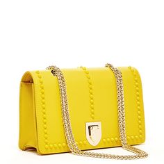 The Josie will take you through the seasons looking trés chic. Made with smooth leather, this trendy forward yellow leather purse features decorative leather studs on its front flap. With a buckle closure, the fabric-lined interior includes a zip pocket, cell phone slip and 6 credit card slots. Its elegant light gold chain strap can be worn long as a stylish crossbody or doubled up for a shorter shoulder bag style. The fashionable Josie worn day to night for all occasions. More details about thi Elegant Leather Shoulder Bag With Rivets, Formal Leather Bags With Studs, Elegant Rectangular Bag With Rivets, Elegant Rectangular Bags With Rivets, Designer Bags With Rivets, Elegant Rectangular Studded Shoulder Bag, Yellow Leather Bags With Metal Hardware, Formal Yellow Shoulder Bag With Chain Strap, Yellow Leather Bag With Chain Strap