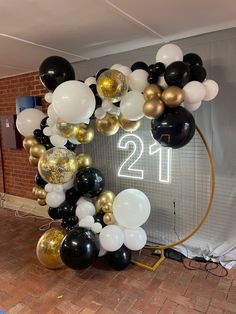 balloons are arranged in the shape of a circle and number twenty one is on display