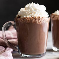 two glasses filled with hot chocolate and whipped cream