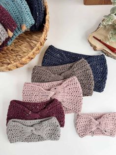 four crocheted headbands sitting on top of a table