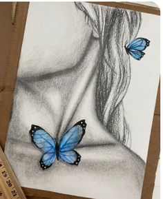 a drawing of a woman's face with two blue butterflies on her chest, and a ruler next to it