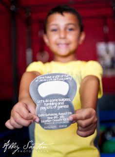 a young boy is holding up a plaque